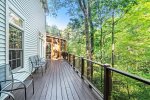 Sprawling deck on the backside of the house with views out over the ravine and trees